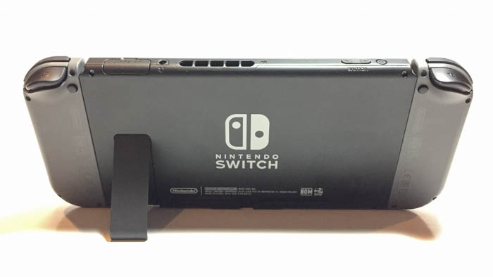 nintendo switch console back with controllers