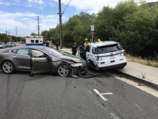 Tesla car hits parked California police car